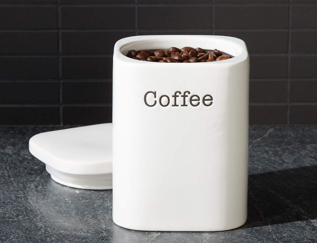 enamel coffee container filled with beans and labeled