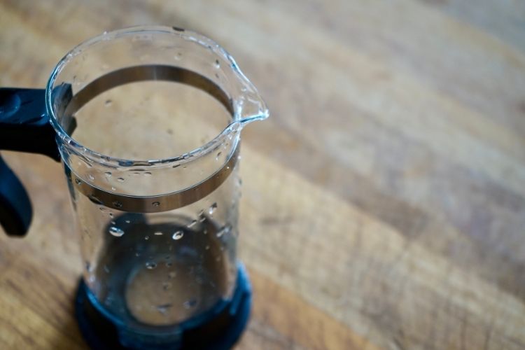 empty French Press Coffee Maker with water droplets inside
