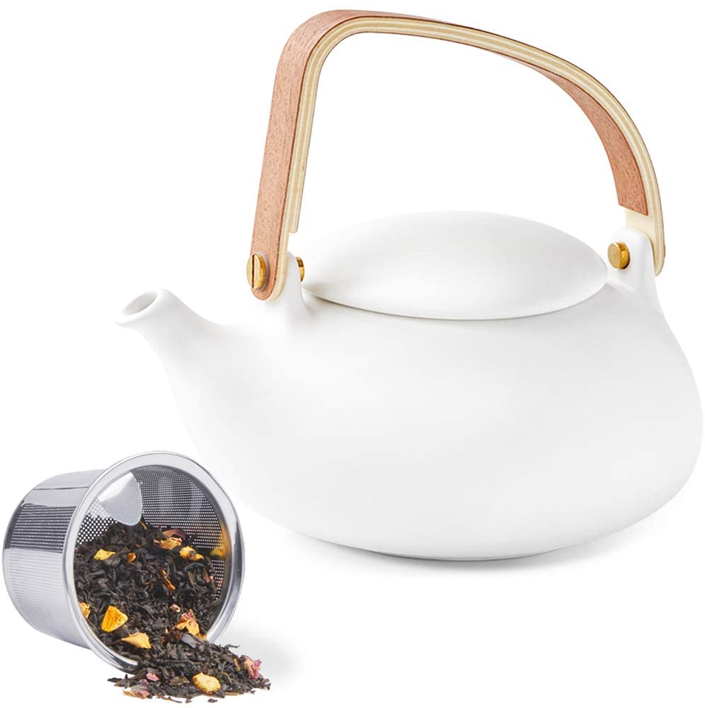 white ceramic tea kettle with wooden handle