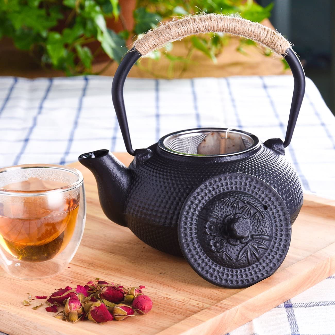 black iron tea kettle with cup of tea