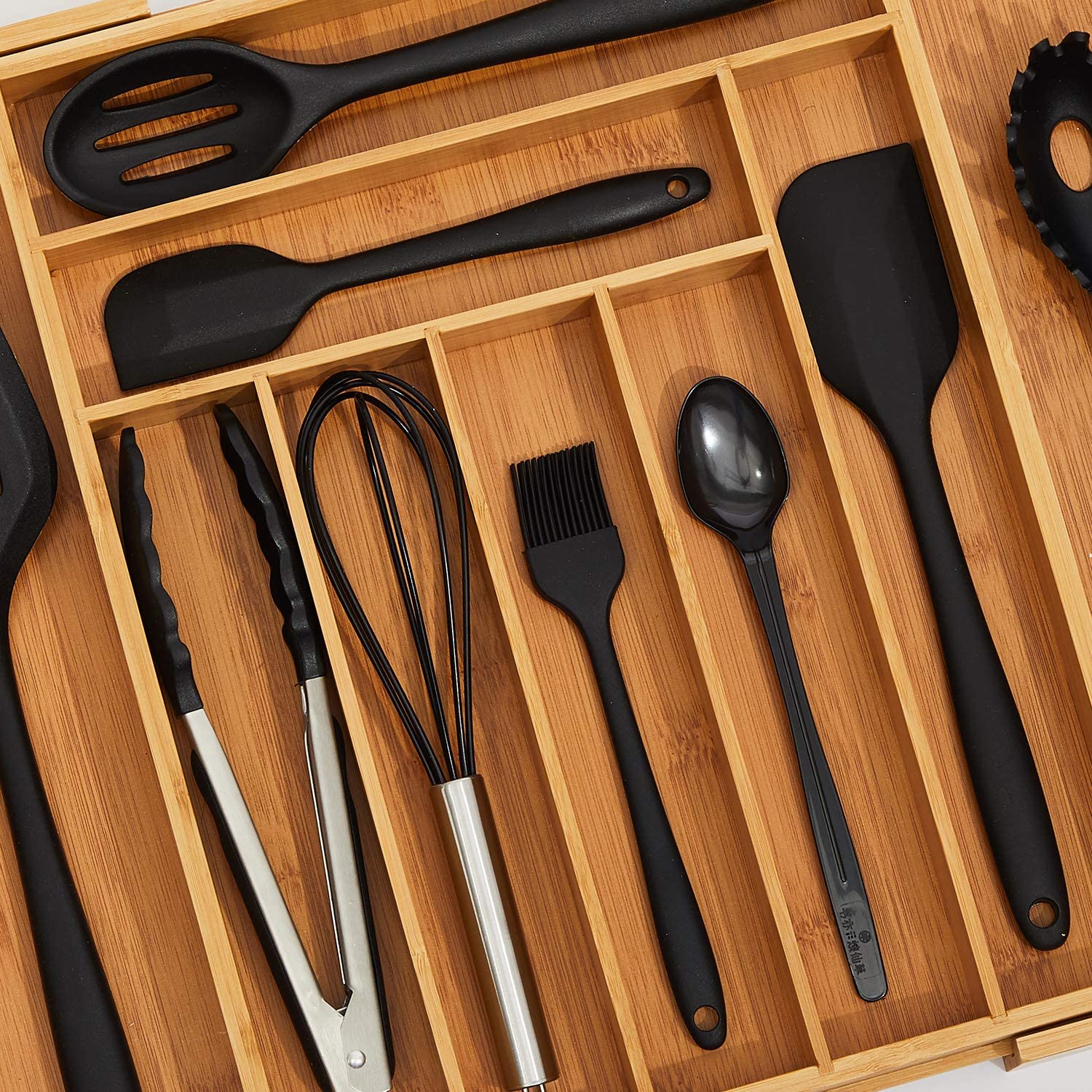 black utensils in bamboo drawer organizer
