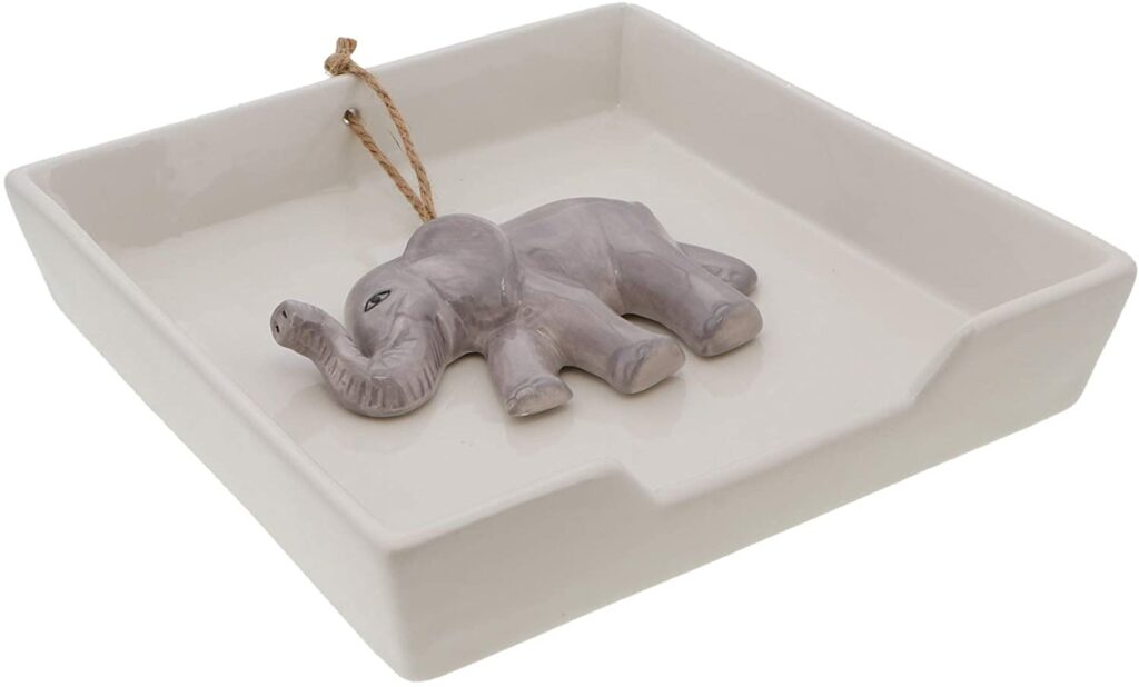 white ceramic napkin holder with elephant roped weight