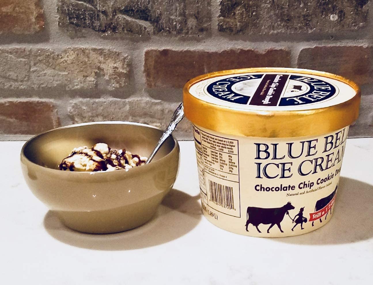 blue bell ice cream carton next to gold ice cream bowl