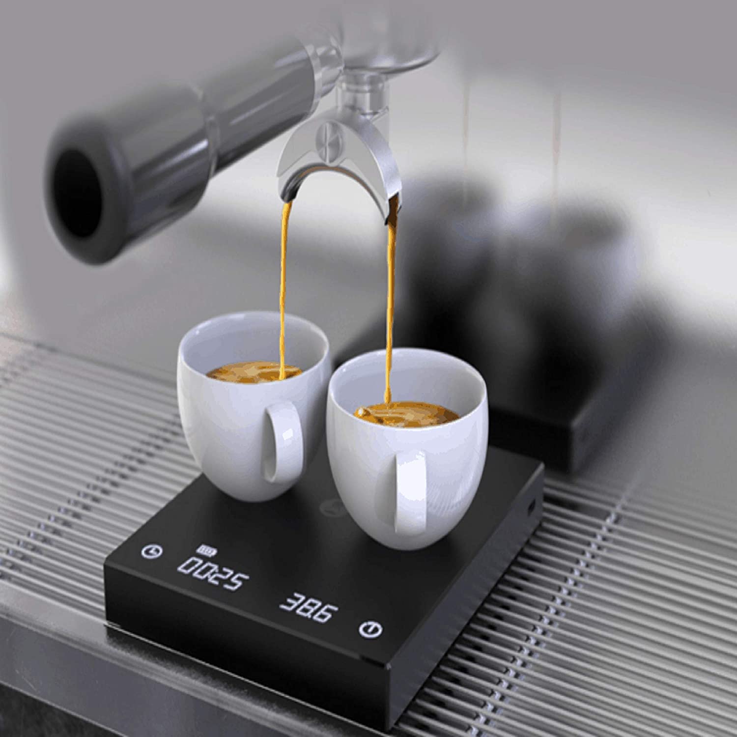 espresso pouring from machine into two cups